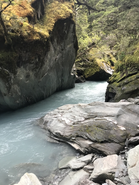       Rushing blue waters through rocky gorges.
  