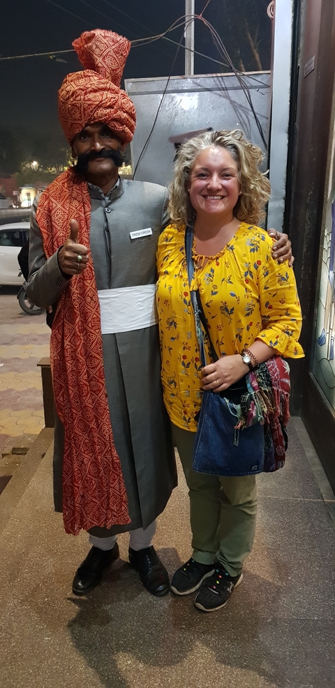       Two people posing together indoors.
  