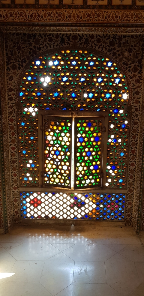       Close-up of a colorful stained glass window.
  