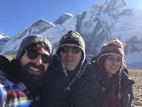       Group of people with snowy mountains in the background.
  