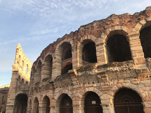 Ancient Roman amphitheater ruins basking in sunlight.