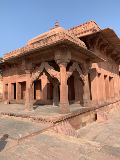 Traditional Indian architecture with ornate pillars and carvings.