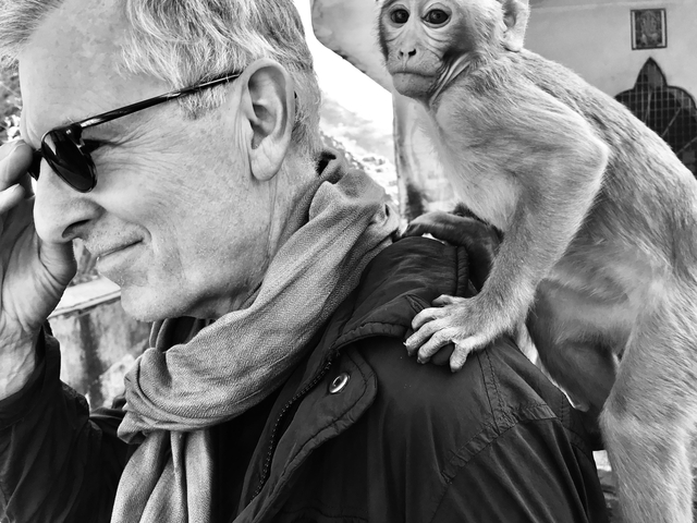       Black and white close-up of a person with a monkey on their shoulder.
  