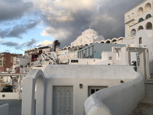 White buildings with domes in an island setting.