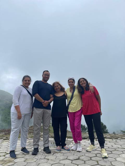       Group of people smiling outdoors.
  