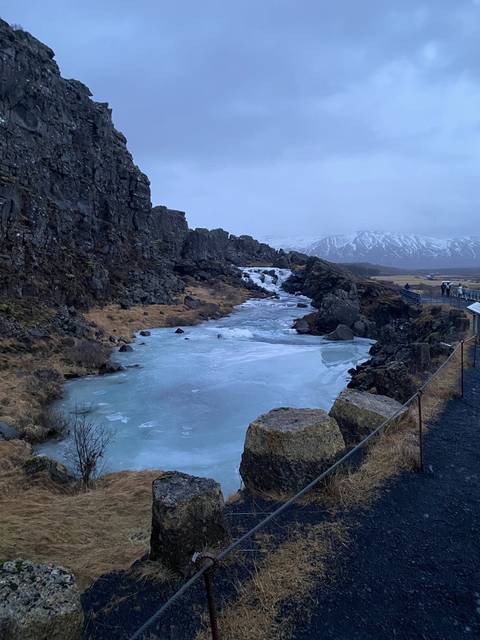 Frozen lake with rocky surroundings.