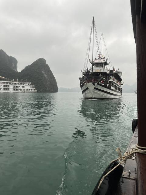 A boat on a body of water with land in the background.