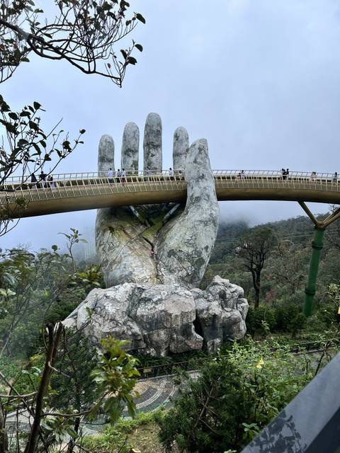 Golden Bridge with giant hand sculpture