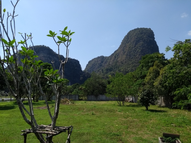Scenic landscape view with lush greenery and rock formations.