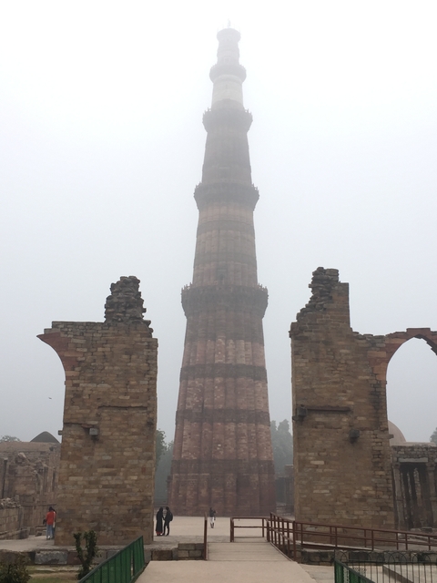       Tall tower surrounded by mist and stone ruins.
  