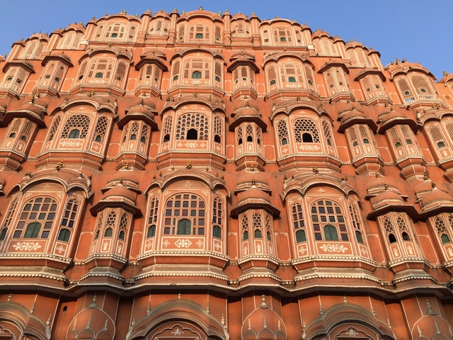       Ornate pink facade with numerous windows.
  