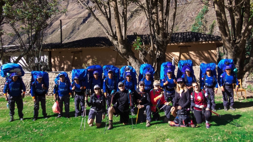       Group of hikers and guides with backpacks.
  