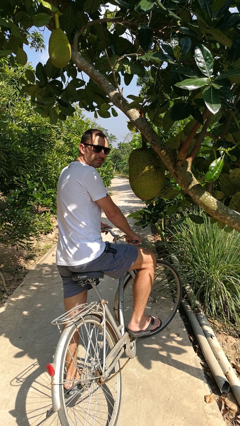       A person on a bicycle in a scenic natural area.
  