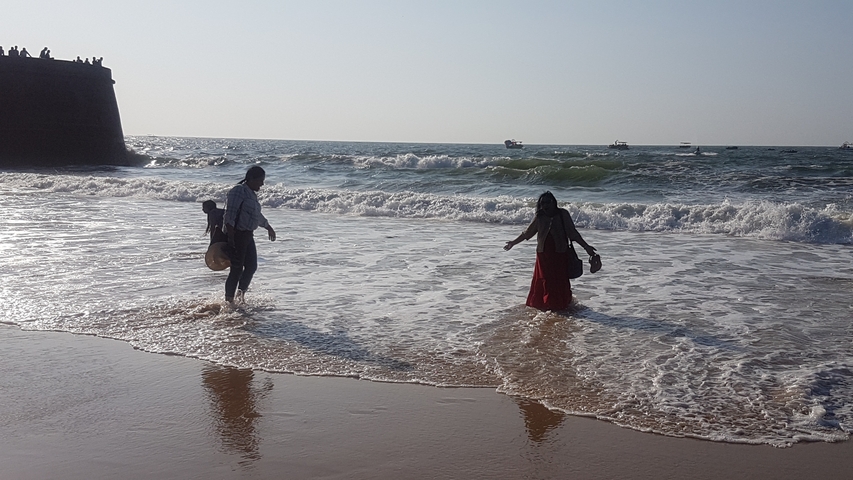 Two people playing in the ocean waves.