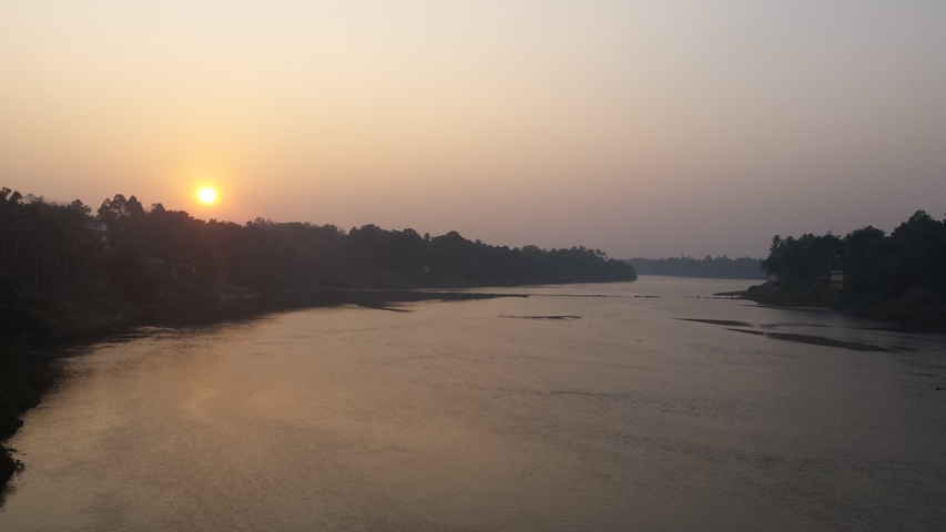       River at sunset surrounded by trees.
  