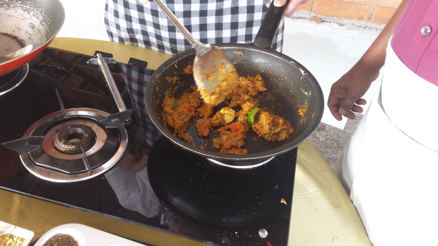       Close-up of a dish being cooked in a pan.
  