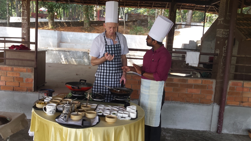       Two chefs preparing food at an outdoor event.
  