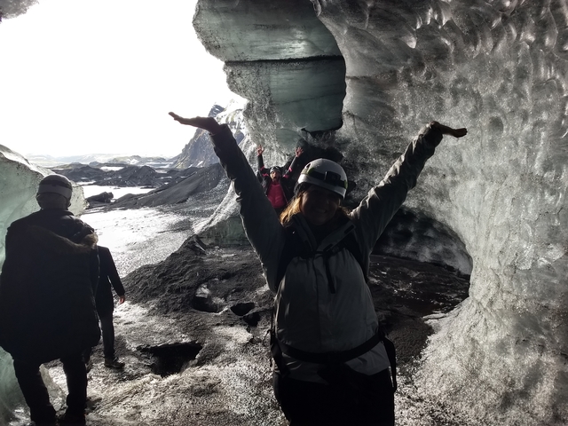 Group exploring inside a glacial ice cave.
