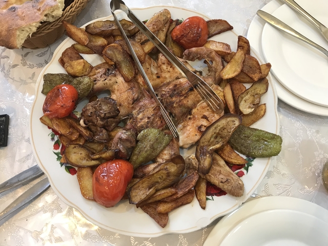       Plate of roasted vegetables and meat.
  