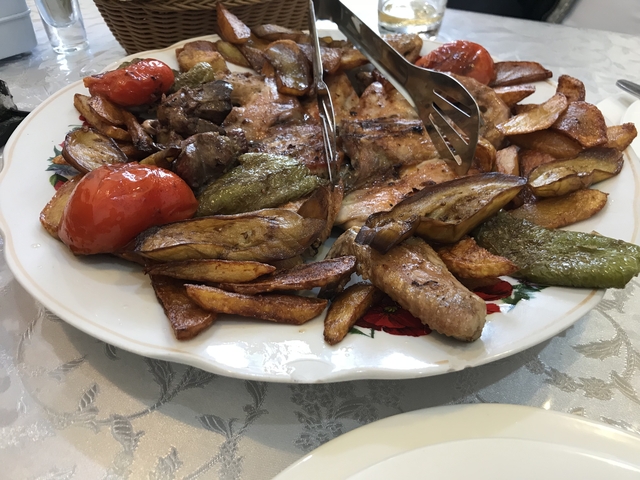 Close-up of a plate of roasted vegetables and meat.