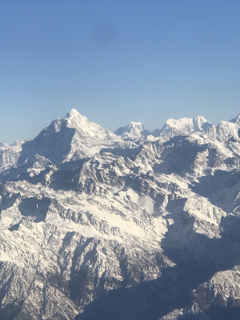       Snow-capped mountain peaks under a clear blue sky.
  