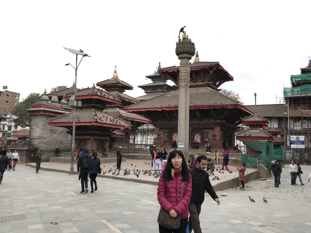       Visitors at a traditional Nepalese temple complex.
  