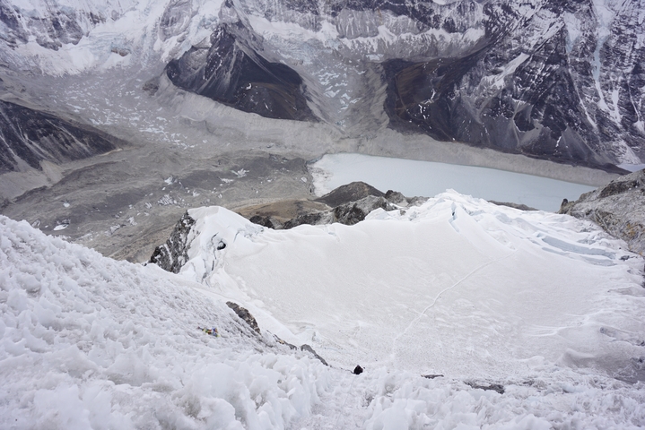 View from a high altitude overlooking a snowy mountain basin.