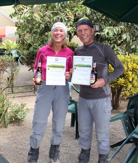       Two people holding certificates with beers
  