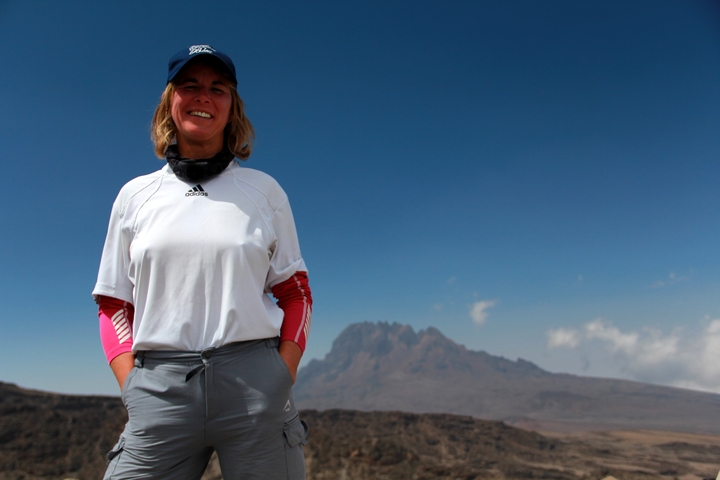       Person standing with Mount Kilimanjaro in the background
  
