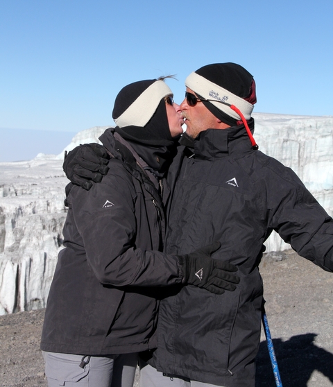      Two people in warm clothing in a snowy environment
  