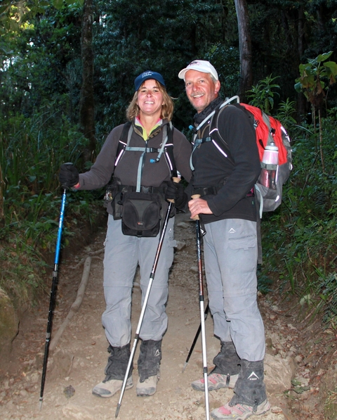       Two hikers in a wooded trail
  