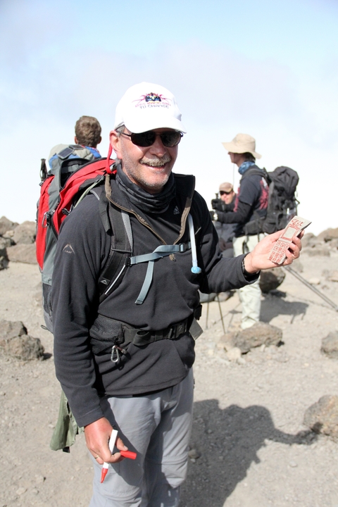       Person holding a chocolate bar with hiking gear
  