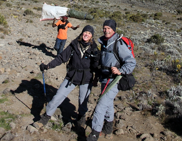 Hikers posing on a trekking path, surrounded by a rugged landscape.