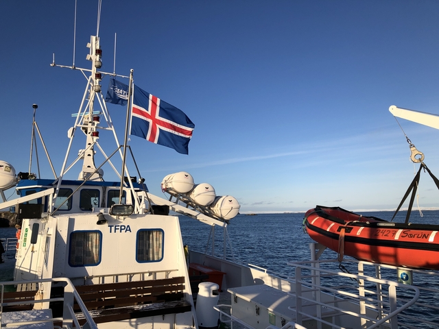       A ship with the Icelandic flag docked at sea
  