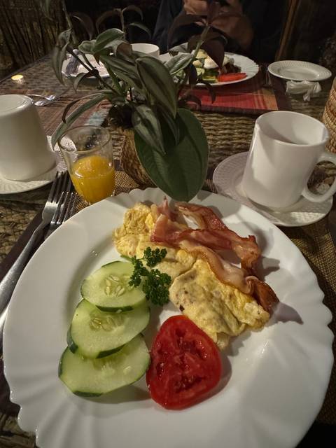      A plate of breakfast food on a dining table.
  