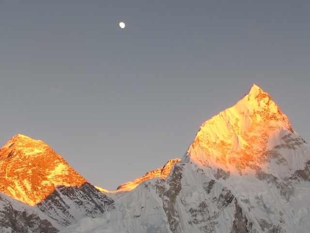 Mountain peaks glowing orange under the sunlight.