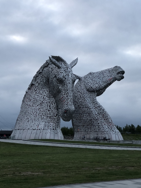 Two horsehead sculptures made of metallic pieces.