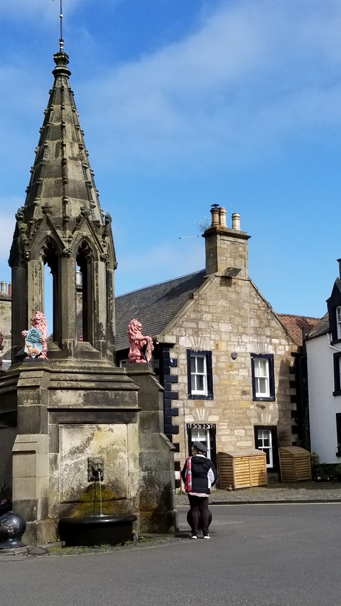 Close-up of a historic stone building with gothic sculptures.