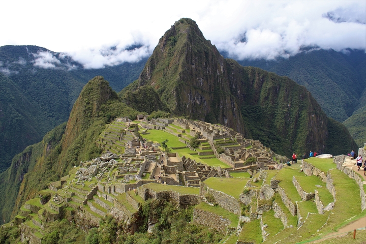       View of Machu Picchu ruins with mountains in the background.
  