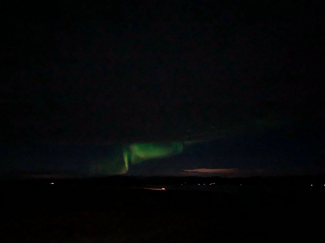       Northern lights visible in the night sky.
  