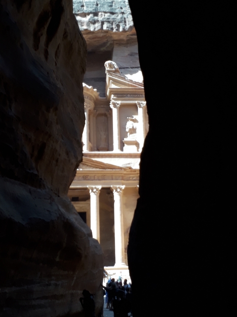 View of the Petra Treasury framed by a narrow canyon.