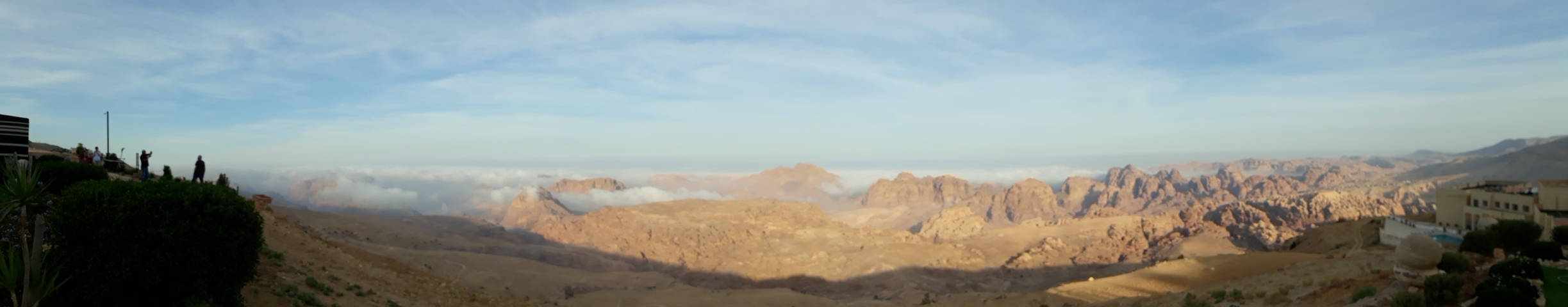 Distant mountain landscape with scattered clouds.