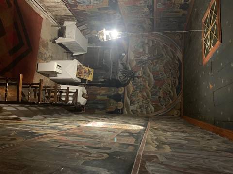       Orthodox church interior with colorful frescoes.
  