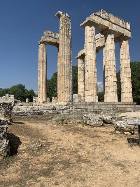       Ruins of an ancient temple with standing columns.
  