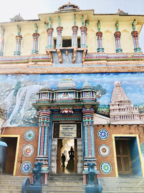 Colorful temple mural with intricate carvings.