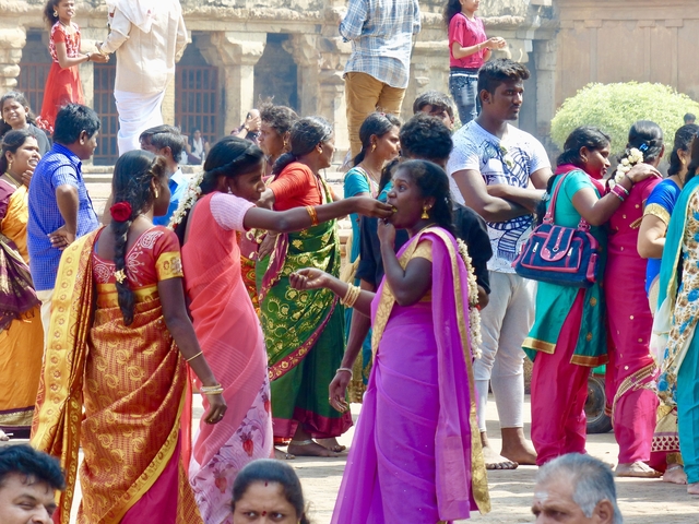       Group of people in vibrant clothing at a festival.
  