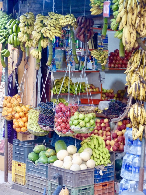 Colorful market stall with a variety of fruits.