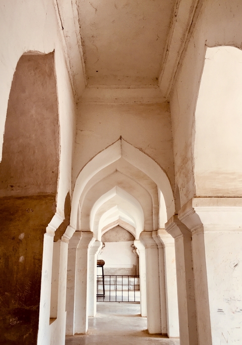       Interior view of a historical building arch.
  