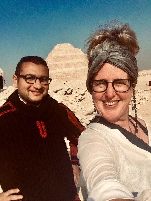       Two people taking a photo in a desert setting.
  