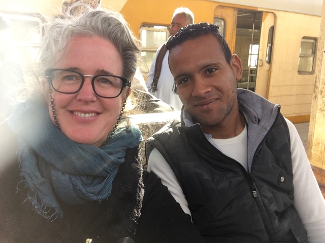       Two people sitting together on a boat.
  
